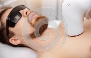 Man torso under treatment in hair removal laser epilation studio