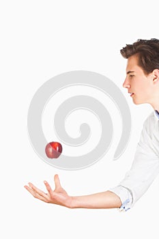 Man Tossing Red Apple in the Air