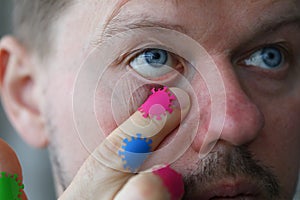 Man touches his eyes with microbes coronavirus