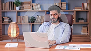 Man touches massages his sick neck, making constrained head movements.