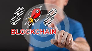 Man touching a blockchain success concept on a touch screen