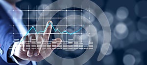 Man touching in graph in screen on bokeh background