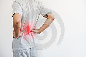 A man touching his back, with red highlight. Back pain, backache and waist pain, on white background with copy space