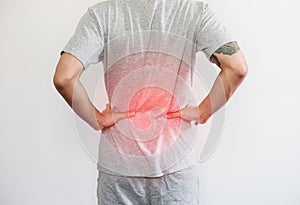 A man touching his back, with red highlight concept of back pain and waist pain concept