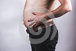 Man touching his fat belly on white background - Man fat overweight show belly