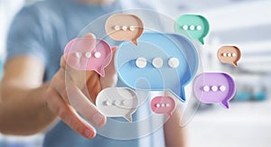Man touching with his fingers digital speech bubbles talk icons. Minimal conversation or social media messages floating in front