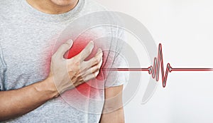 A man touching his heart, with heart pulse sign. Heart attack, and others heart disease photo