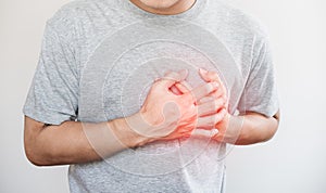 A man touching his heart, with red highlight of heart attack, and others heart disease concept, on white background