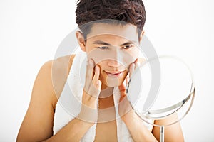 man touching his smooth face after shaving