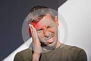 Man touching his temple and having strong tension headache. Cluster headache