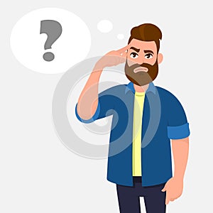Man touching his temples and questioning. Man holding finger on head and in the thought bubble question mark appearing. photo