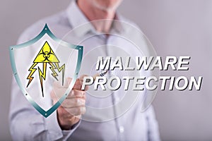 Man touching a malware protection concept on a touch screen