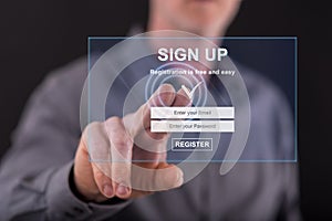 Man touching a signup concept on a touch screen