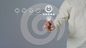 Man touching virtual screen on the happy smile face icon and five stars to give satisfaction in service.