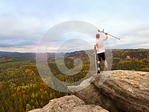 Man tourist after accident use knee brace features and forearm crutches. Man looking over