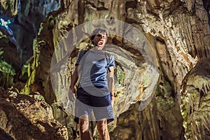 Man tourist in Hang Sung Sot Grotto Cave of Surprises, Halong Bay, Vietnam