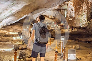 Man tourist in Hang Sung Sot Grotto Cave of Surprises, Halong Bay, Vietnam