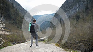 Man tourist hiker with backpack enjoying scenic view mountain river landscape. Travel hiker looking away. Travel, people