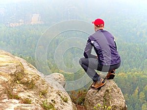 Man tourist hiker or trail runner looking at inspirational rocky landscape