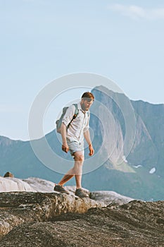 Man tourist hiking solo traveling in Norway vacations eco tourism in mountains