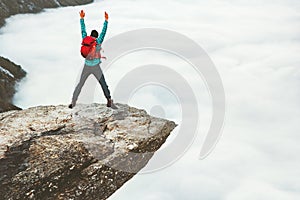 Man tourist jumping on Trolltunga rocky cliff mountains