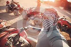 Man tourist make selfie photo on quad bike ATV safari in desert Sharm Hurghada, Egypt