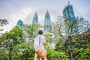 Man tourist in Malaysia looks at the Petronas Twin Towers