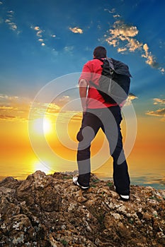 Man Tourist on the mountain edge sunset sea sky