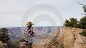 Man Tourist Talking On The Radio Traveling The Grand Canyon