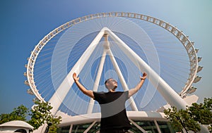 The man tourist threw up her hands in delight at the sight Ain Eye DUBAI - One of the largest Ferris Wheels in the World,