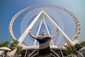 The man tourist threw up her hands in delight at the sight Ain Eye DUBAI - One of the largest Ferris Wheels in the World,