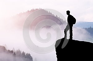 Man tourist on the top of the mountain