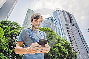 Man Tourist using navigation app on the mobile phone. Navigation map on a smartphone in a big city