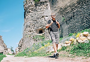 Man tourist walk on the old castle ruin territory