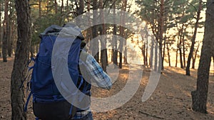 Man tourist is walking through the woods with a backpack on a hike. concept travel tourism adventure overcoming