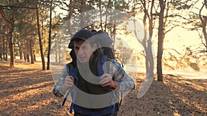 Man tourist is walking through the woods with a backpack on lifestyle a hike. concept travel tourism adventure