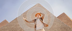 Man tourist walks background of pyramids in Giza Cairo Egypt, sun light travel banner