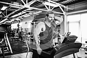 Man with a towel beside a treadmill