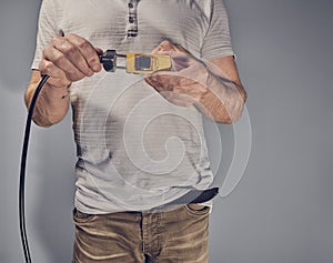 Man with toy car and electricity plug