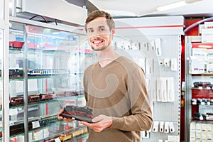 Man in toy store buying model railroad