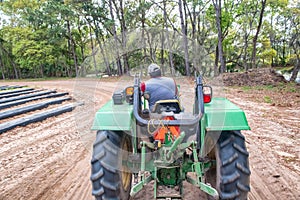 Man on the tractor working in countryside road