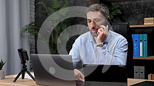 Man trader talking on mobile phone with investor company on stock exchange