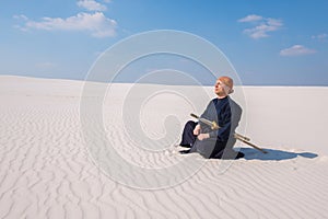 Man in traditional clothes meditates during the practice of mart