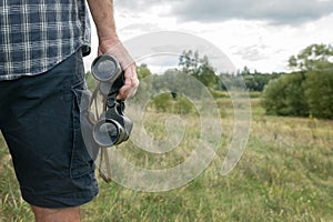 Man on the trail holding binoculars