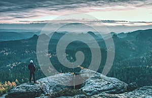 man on the trail looking on high mountain peak