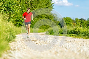 Man trail running on country road