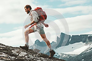 Man trail running in mountains with backpack
