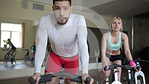 Man training on exercise bike in fitness centre