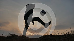 Man is training freestyle bal Hacky On Sunset lifestyle Sack silhouette freestyle concept. man playing soccer stuffing a
