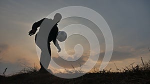 Man is training freestyle bal Hacky On Sunset Sack silhouette freestyle concept. lifestyle man playing soccer stuffing a